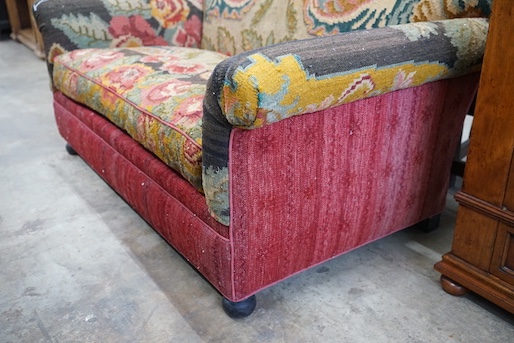 An early 20th century carpet upholstered scroll arm two seater settee, length 150cm, depth 80cm, height 80cm